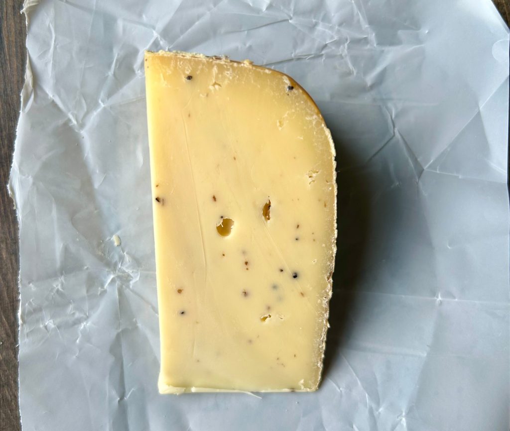 a piece of treur kass bio truffo cheese on parchment paper