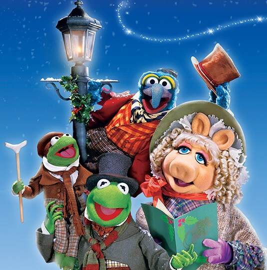 four muppets dressed in warm clothing are smiling next to a street lamp