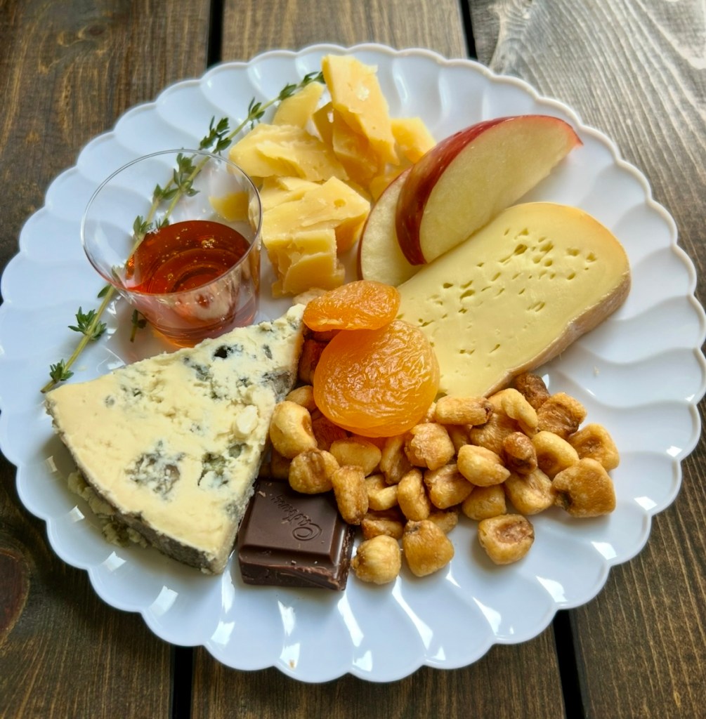 a trio of Irish cheeses on a plate with accompaniments
