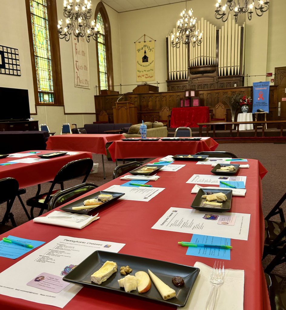 a chapel room with a table covered in cheese platters